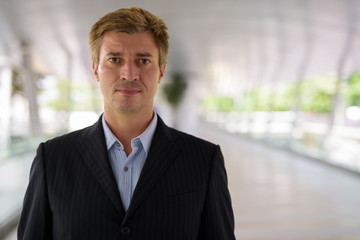 Businessman relaxing at the footbridge in Bangkok, Thailand