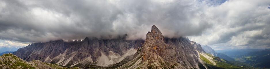 Panoramic clouds over the Sextner Rotwand, a mountain crest in the Dolomites