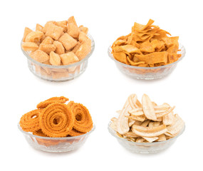 Collage of Indian Street Food Salty And Sweet Shakkar pare, Chakli, Soya Chips, Banana Chips isolated on White Background