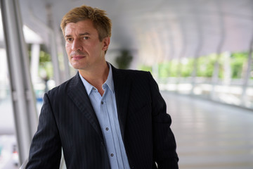 Fototapeta premium Businessman relaxing at the footbridge in Bangkok, Thailand