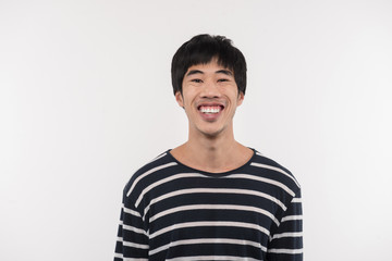 Happy smile. Cheerful Asian man looking at you while standing against white background