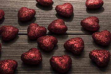  Red hearts on a brown wooden background