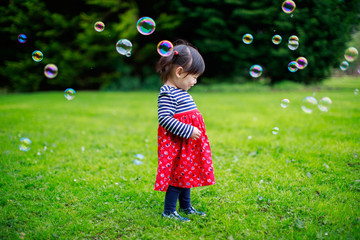 baby girl play bubble at spring garden