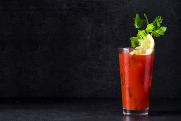 Bloody Mary cocktail in glass on black background. Copyspace