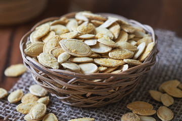 Roasted and salted pumpkin seeds in woven basket