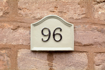 House number 96 sign fixed to wall