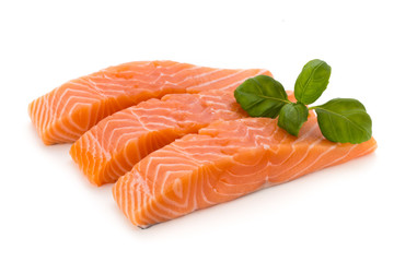 Fresh salmon fillet with basil on the white background.