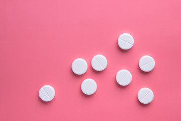 white pills on a pink background, medicine