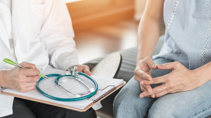 Doctor or psychiatrist consulting and diagnostic examining stressful woman patient on obstetric -...
