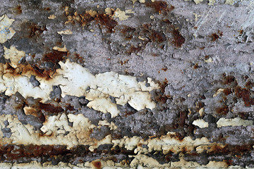 Rusty iron surface with cracks and peeling paint