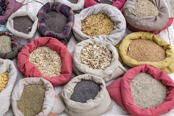 A variety of colorful spices in the Asian market are packed in pouches. Ladakh, Leh, India. Close up