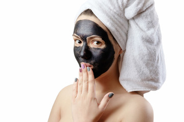 close-up portrait beautiful woman with facial black mask on white background, girl with a white...