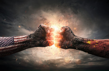 Conflict, close up of two fists hitting each other over dramatic background with copy space