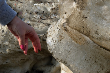 Pieces of ice in warm hands