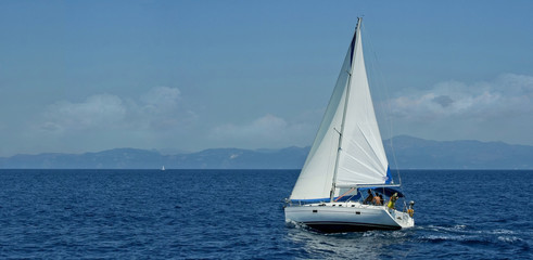 White sailboat traveling the sea