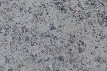Concrete background with stone impregnations and sand.
