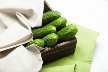 Fresh cucumber in brown wood box, agriculture.