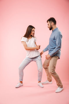 Full length portrait of a cheerful young couple dancing