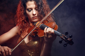 Violinist girl performs on stage.