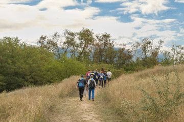 Group of hikers walking in mountains.
