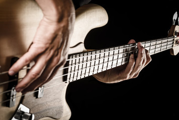 hands of rock bassist playing bass - obrazy, fototapety, plakaty