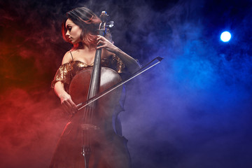 The cellist girl performs on stage.