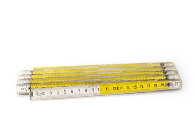 Old yellow construction folding meter on the white background