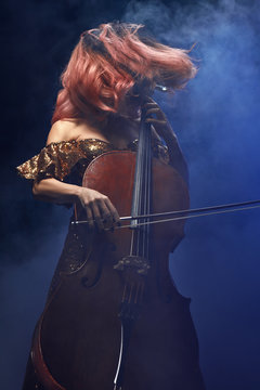 The cellist girl performs on stage.