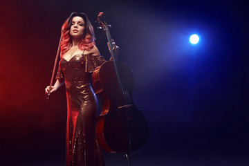 The cellist girl performs on stage.