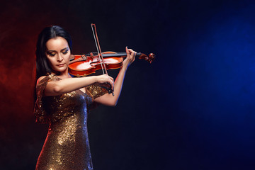 Violinist girl performs on stage.