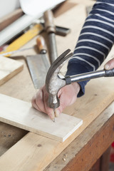 carpeter hammering nail.copy space