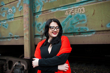 Fototapeta na wymiar Brunette girl wear in black with glasses in railway station.