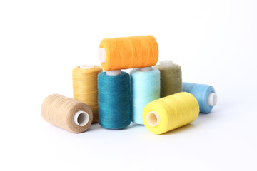 sewing thread of different colors isolated on white.