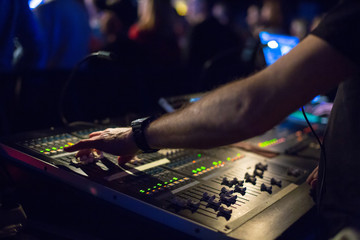 Soundman working on the mixing console.