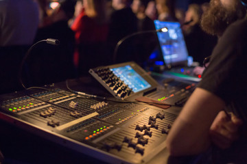 Soundman working on the mixing console.