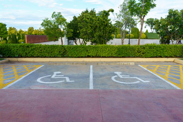Wheelchair sign at car park reserved for cripple person.