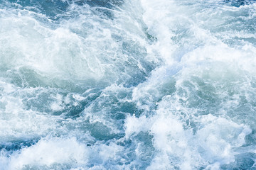 Obraz na płótnie Canvas Abstract blue background of foamy sea wave