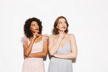Portrait of two pretty well dressed women looking up