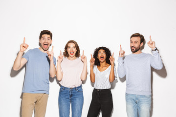 Group of happy multiracial people pointing fingers up