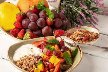 Fruit berry salad with yogurt and granola for healthy breakfast or dessert