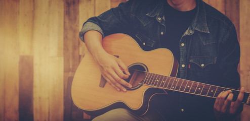 hand playing acoustic guitar, close up on musical instrument Relaxation Music sound hobby passion concept.