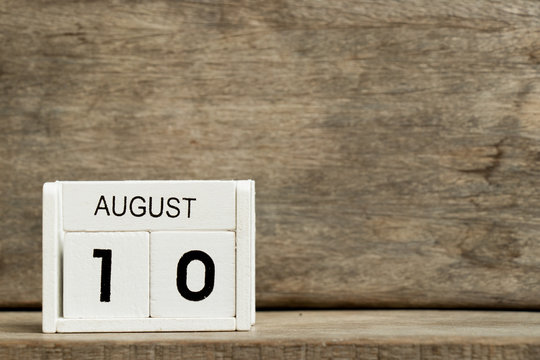 White block calendar present date 10 and month August on wood background