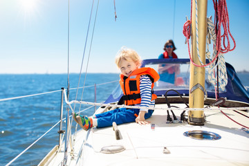 Kids sail on yacht in sea. Child sailing on boat.