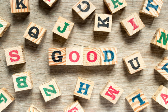 Letter block in word good with another on wood background