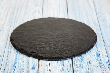 black slate board on a wooden background