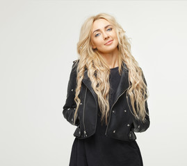 portrait of attractive beautiful young blond woman in black jacket on white background.