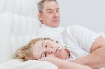 Fototapeta na wymiar old man with sick wife on the bed