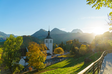 Landscape with a traditional church and autumn forest, Gruyeres, Switzerland