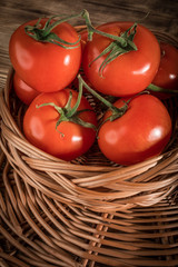 Fresh tomatoes in a wicker basket.