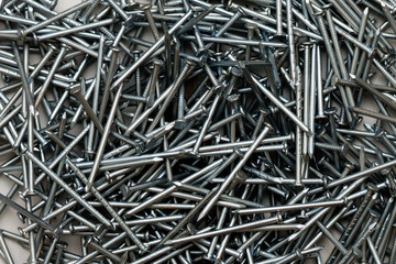 Background of silver steel long building nails